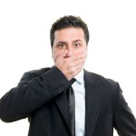 man with hand on mouth